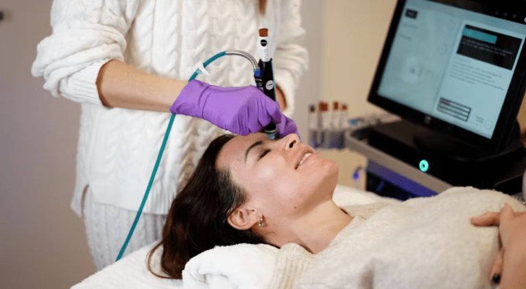 A HydraFacial device infusing active serums into the skin to cleanse, hydrate, and restore glow.