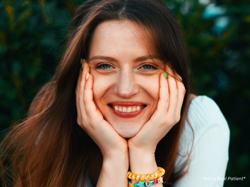 Woman with naturally glowing skin smiling confidently after subtle facial enhancement in Melbourne.