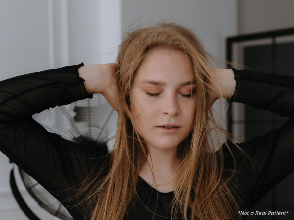 Stressed woman showing visible tension that can affect skin health