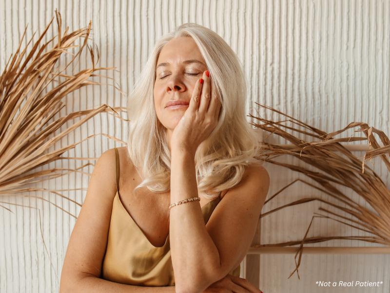Woman touching her face noticing skin texture changes